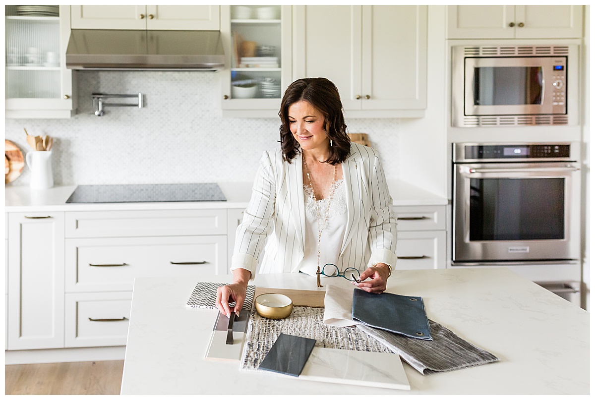 Business owner working with design samples during an Edmonton brand photoshoot