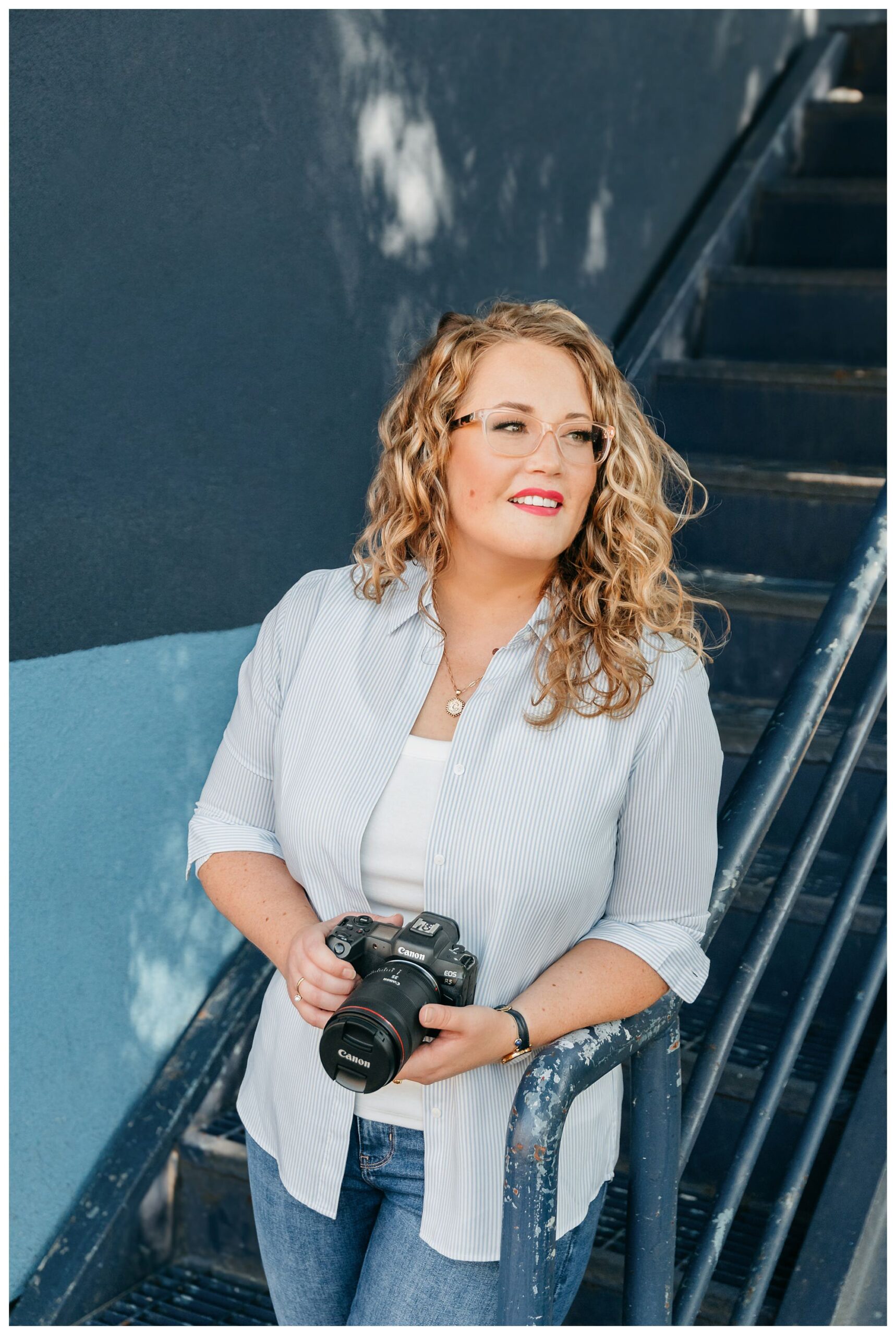 Edmonton brand photographer Christina Louise holding her camera